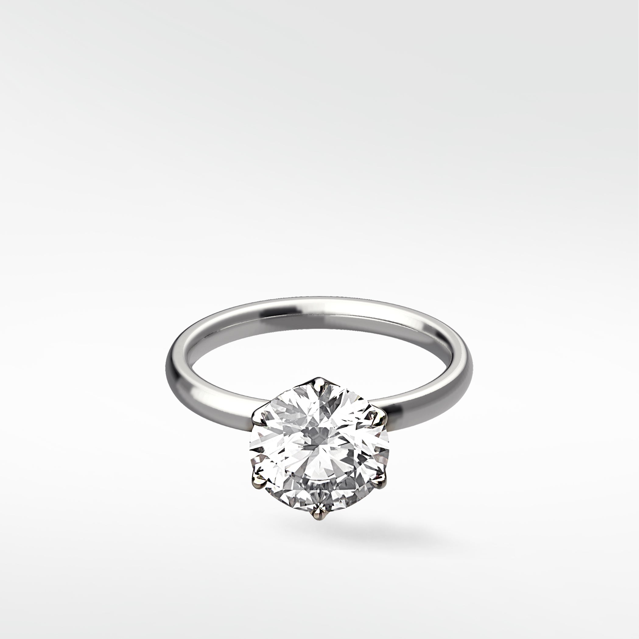 Lily Engagement Ring with a round solitaire diamond in a six-prong petal claw setting on a white gold band.