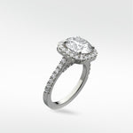 Angled view of the Sequoia Diamond Engagement Ring in platinum with a halo setting and a pavé diamond band against a white background.